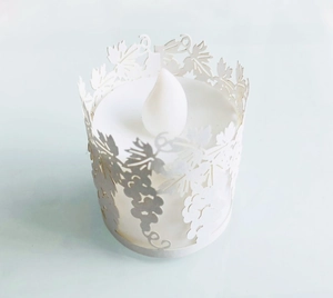 Close-up of laser-cut paper lampshade with grape pattern and LED electronic candle light