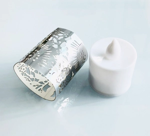 Detail of silver hollow metal candle cover with sun and plant pattern and LED tealight