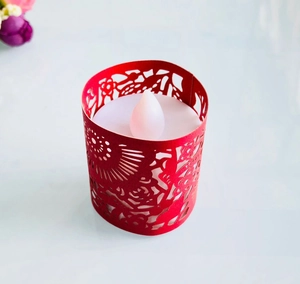 Close-up of pink laser-cut floral paper sleeve for LED candle festive decorations