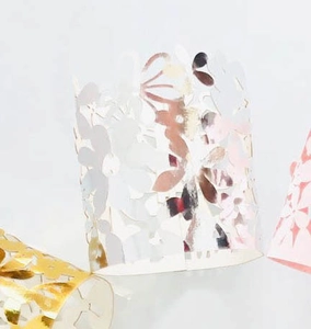 Detail of laser-cut floral paper wraps for LED candles in gold, silver and pink
