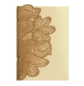 Macro view of laser-cut floral patterns and lace edges on metallic wedding invitations