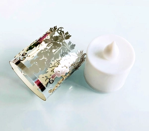 Detailed view of laser-cut gold grape leaf sleeve with LED candle light for party decor