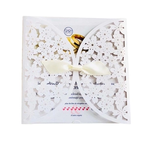Elegant laser cut white butterfly wedding invitation card with a delicate silk ribbon bow