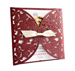 Elegant burgundy laser-cut invitation card with butterfly cutout and cream silk bow