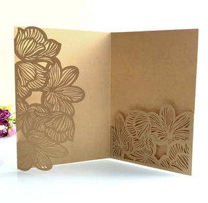 Macro detail of laser-cut hollow floral patterns on premium kraft paper wedding invitation