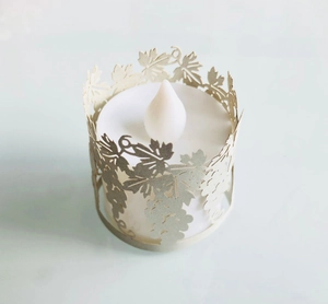 Top view of LED candle with intricate laser-cut grape leaf pattern paper shade