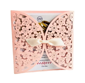 Pink laser cut butterfly wedding invitation with white satin bow and elegant inner page