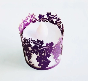 Detail of purple laser-cut grape vine paper wrap with a white LED electronic candle light