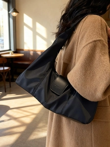 Versatile black nylon crescent shoulder bag with leather flap for women commuting