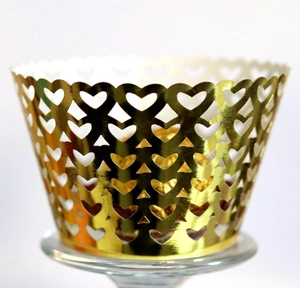 Detailed laser-cut golden hollow heart pattern cupcake wrappers with wavy top edge