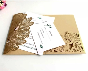 Detail of laser-cut lace invitation set with floral cover and elegant response cards