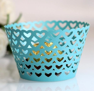 Detail of sky blue laser-cut heart pattern cupcake wrapper for wedding party decor