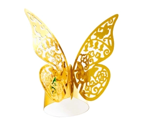 Macro shot of laser-cut golden butterfly napkin ring with intricate hollow patterns