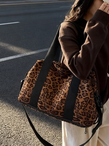 Large leopard print travel tote bag with wide black shoulder straps for fitness