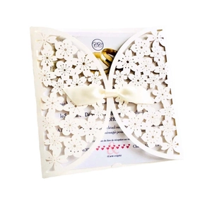 Laser cut ivory wedding invitation card featuring butterfly pattern and white ribbon bow