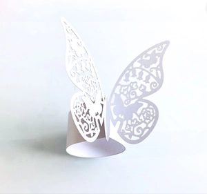Elegant white laser-cut butterfly paper napkin ring with intricate floral patterns for weddings