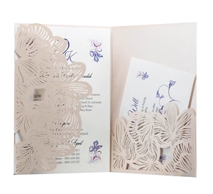 Elegant laser-cut floral invitation suite in light pink with inner printed cards