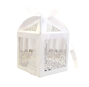Detail of white laser-cut rose hollow candy box with an organza ribbon tie