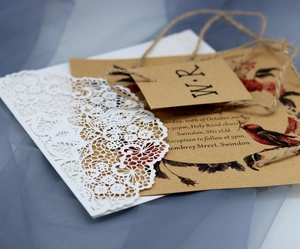Rustic kraft paper wedding invitation with laser cut lace cover and twine bow