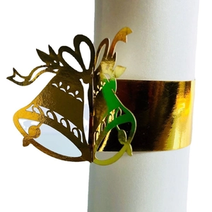 Golden Christmas napkin ring with bells and bow cut-out design on a white background
