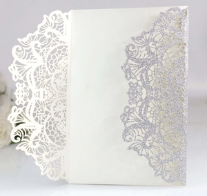 Detailed laser-cut ivory wedding invitation sleeve with silver glitter floral accents