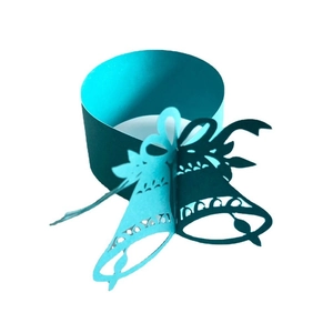 Teal laser-cut paper napkin rings with Christmas bell and bow design for festive tables