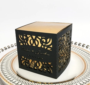 Laser cut black and gold cube gift box with hollow pattern and wedding date detail