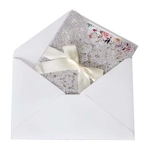 Laser cut rose gold glitter wedding invitation set with floral card and satin ribbon bow