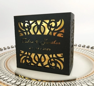 Custom laser-cut black and gold hollow wedding favor box with elegant vine patterns