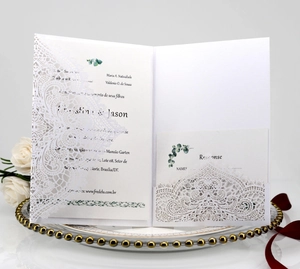 Detailed view of laser-cut lace wedding invitation with gold leaf and response card
