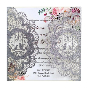 Detailed silver laser-cut wedding invitation with glitter floral lace and bird motifs