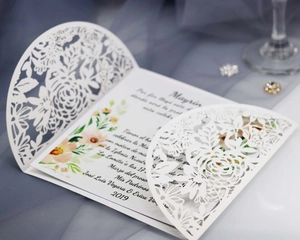 Laser cut floral wedding invitation with white paper sleeve and colorful insert card