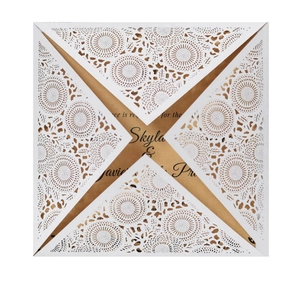 White laser cut floral wedding invitation with brown kraft card insert on white background