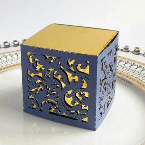 Detail showing the laser-cut vintage lace pattern of the blue and gold candy gift box