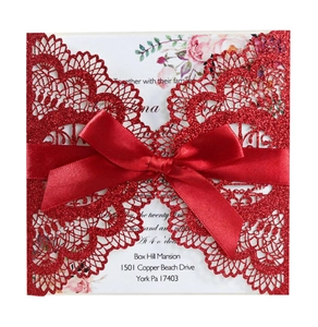 Red glitter laser cut wedding invitation with decorative bow and floral insert card