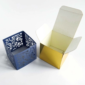 Detail of laser-cut royal blue lace sleeve and metallic gold square gift box set