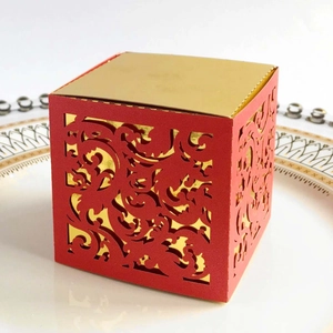 Detailed laser-cut pattern on red and gold wedding candy box for small gifts