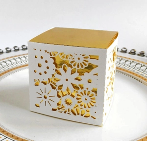 Detail of laser-cut floral pattern on gift box with elegant gold metallic lining