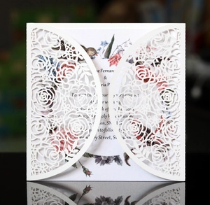 Detailed laser-cut white rose invitation card with floral insert and elegant mirror reflection