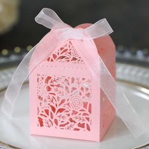 Detailed laser-cut rose floral hollow design on pink gift candy box with ribbon bow
