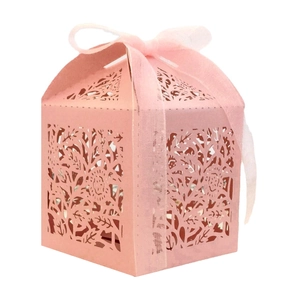 Detailed laser-cut hollow rose pattern on light pink wedding favor gift box with ribbon