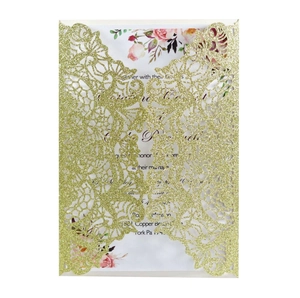 Detail of laser cut gold glitter wedding invitation with floral inner card inserts