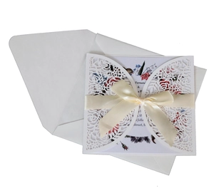 Detailed laser-cut rose wedding invitation set with cream silk ribbon and floral insert