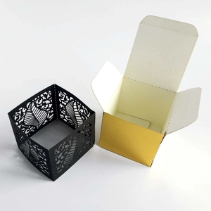 Laser cut pearl paper wedding favor boxes in black and gold with hollow heart pattern