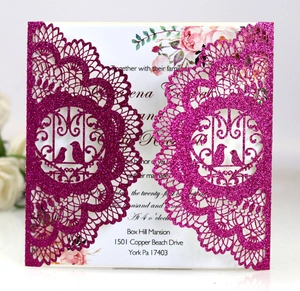 Detail of rose red glitter laser-cut wedding invitation with elegant floral patterns
