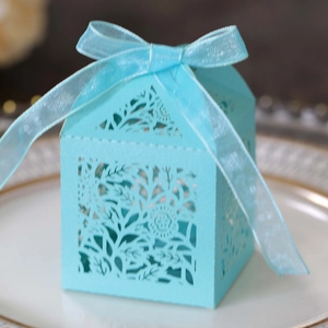 Detail of laser-cut floral paper gift box in Tiffany blue with elegant ribbon bow
