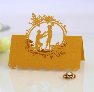 Elegant gold laser cut table place card featuring a romantic proposal wedding silhouette
