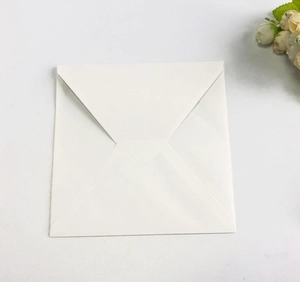 Close-up of square white paper envelope with cross-fold closure for wedding invitations