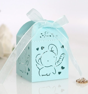 Detail of light blue laser-cut candy box with elephant pattern and ribbon bow