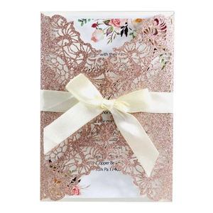 Elegant laser cut rose gold glitter wedding invitation with floral insert and ribbon bow